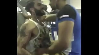 A couple of hot guys from India kissing each other passionately inside a gym
